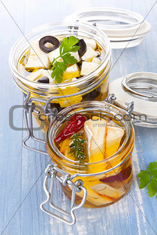 Marinated cheese in glass jar.