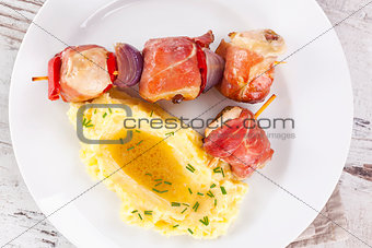 Delicious poultry and bacon kebab.