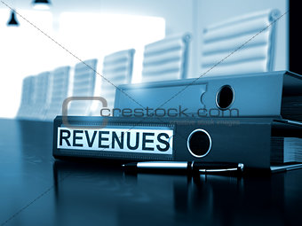 Revenues on Office Folder. Toned Image.