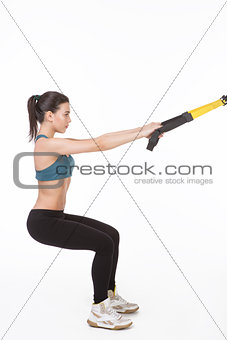 Woman training with suspension trainer sling