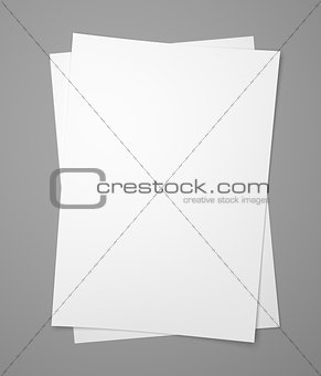 Two white paper sheets on gray