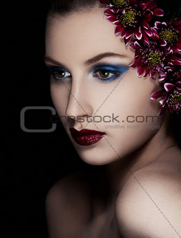 Beauty woman with flowers on black background