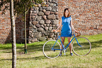 Cheerful young woman and old style bike racing