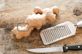 Section of whole raw root ginger on a rustic table