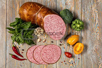 Sausage And Vegetables On An Old Wooden Desk