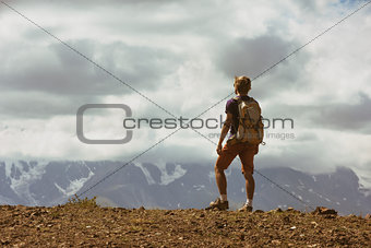 Man backpacker mountains concept
