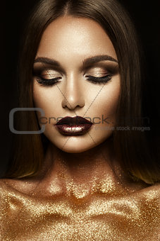 Beautiful girl with gold glitter on her face