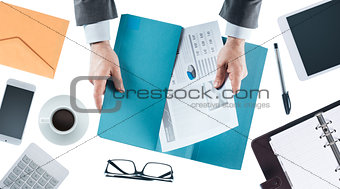Businessman holding financial reports