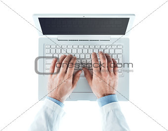 Doctor working at laptop
