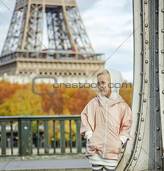 active child on Pont de Bir-Hakeim bridge in Paris looking aside
