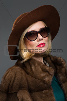 Beautiful mature woman in natural fur coat