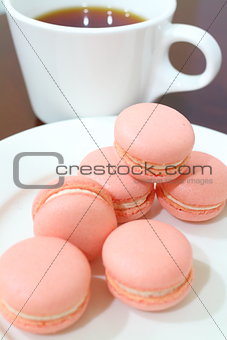 Pink Macarons with tea at the background