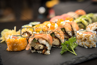 Sushi rolls on a black plate