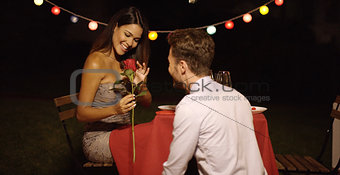 Young man giving a beautiful woman  rose