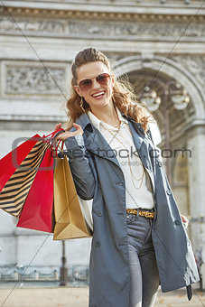 smiling young fashion-monger with shopping bags in Paris, France