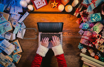Santa typing on a laptop