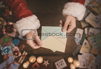 Santa Claus opening a Christmas letter