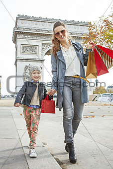 happy mother and daughter near Arc de Triomphe going forward
