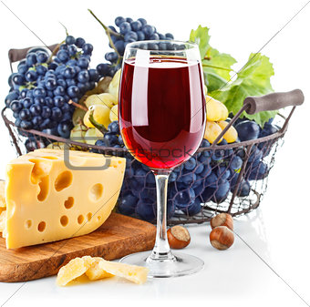 Goblet red wine with blue grapes in