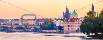Sunset landscape view to Charles bridge on Vltava river in Prague