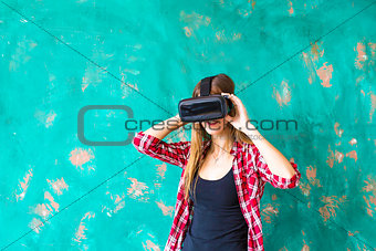 technology, VR, entertainment and people concept - happy young woman with virtual reality headset or 3d glasses
