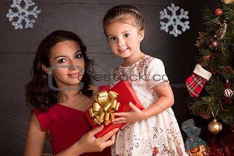 Happy woman and small girl with Christmas gift