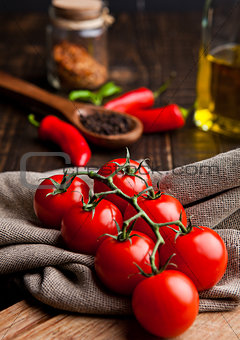 Fresh tomatoes with red and black pepper on kitchen towel