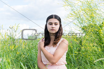 Young girl resting on meadow in summer