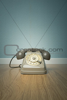 Gray vintage phone on the floor