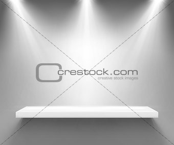 Empty white shelf illuminated by three spotlights