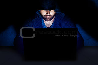Man working at computer in dark room