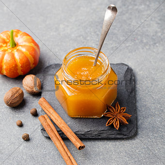 Pumpkin confiture, jam, sauce with spices on stone table Top view