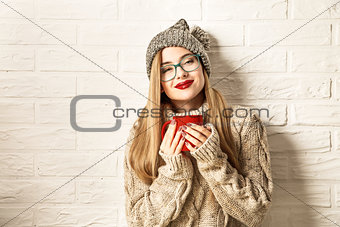 Winter Hipster Girl Enjoying a Cup of Hot Tea