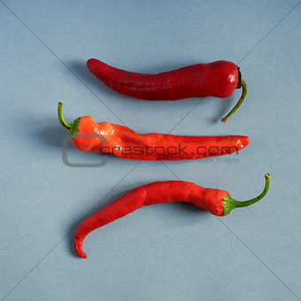 Red hot peppers on textured paper