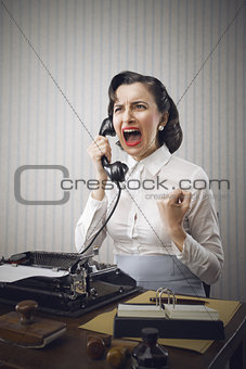 Young Business woman shouting into telephone
