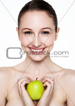Beautiful fitness woman holding healthy apple