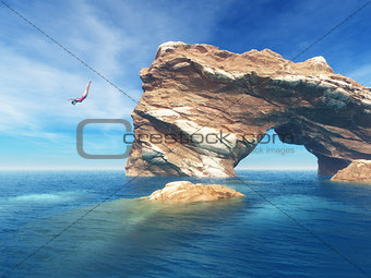 Woman jumping off cliff into the ocean.