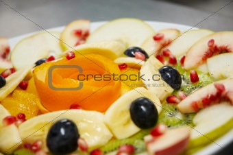 Fresh juicy fruit salad on a plate