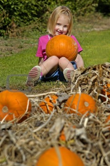 Little Girl Holding Pumpkin