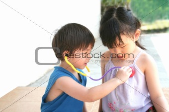 girl & boy playing stethoscope