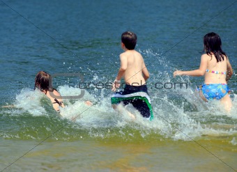 Children running into water