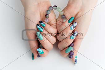 Closeup of woman hands with colorful nails