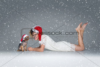 Beautiful girl with yorkie dog in santa cap