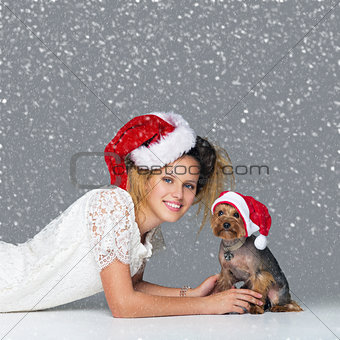 Beautiful girl with yorkie dog in santa cap
