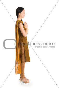 Young girl in Punjabi dress greeting.