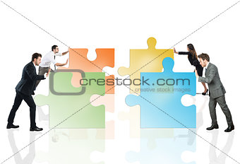 Concept of teamwork and partnership with businesspeople and puzzle.