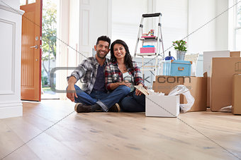 Portrait Of Hispanic Couple Moving Into New Home