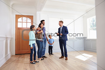 Realtor Showing Hispanic Family Around New Home
