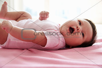 Cute Baby Girl Laying On Pink Blanket