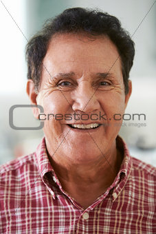 Head And Shoulders Portrait Of Senior Hispanic Man At Home